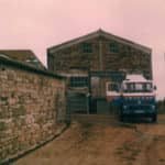 Milk lorry and parlour milking in farmyard