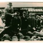 Black and white photograph of sheep being sold at Newport Cattle Market at the Spring Sale - Shows farmers and sellers, including David Dockrill