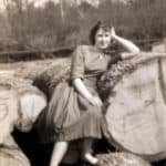 Ruth Stone nee Comer on logs at the sawmill, Forest Road, Newport