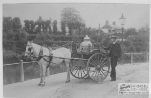 Sepia photograph showing George Guy (aged 16) standing beside Mr Morris's milk float, Newport