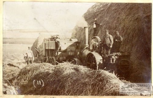 A sepia photograph showing good detail of a threshing machine, crew and steam engine